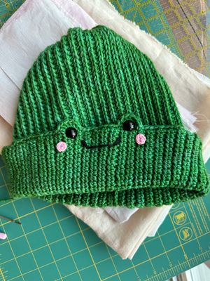 Crochet hat with a frog face